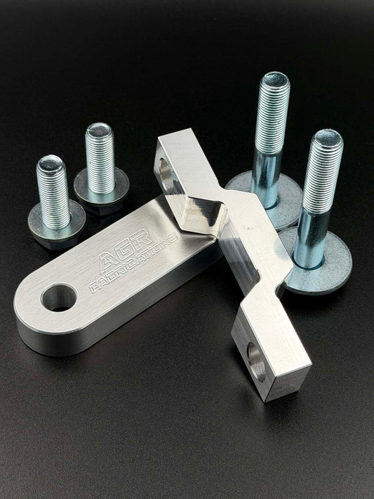 aluminium steering rack spacers displayed on a black background with zinc plated fasteners 